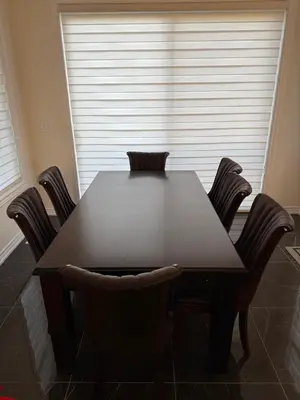 a table and chairs in a room with a window at Modern Bay Vista Getaways in Carrying Place