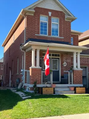 a house with a canadian flag in front of it at Basement in Brampton