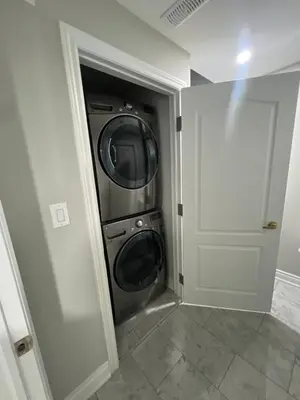a laundry room with a washer and dryer in it at Basement in Brampton