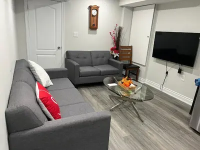 a living room with a couch and a table at Basement in Brampton