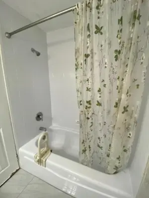 a bathroom with a shower curtain and a tub at Comfy Private Room in Brampton