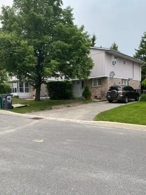 a house with a car parked in the driveway at Comfy Private Room in Brampton