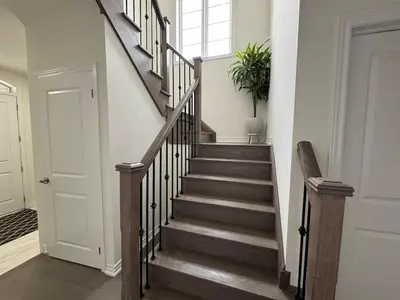 a staircase in a home with a stair case at Lux 3 Bedroom Home near Public Transit in Brampton