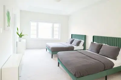 a bedroom with two beds and a couch at Lux 3 Bedroom Home near Public Transit in Brampton