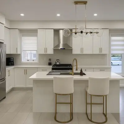 a kitchen with white cabinets and white counter tops at Lux 3 Bedroom Home near Public Transit in Brampton