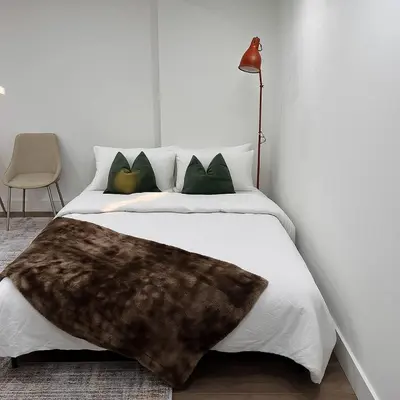 a bedroom with a bed with a fur blanket on it at Lux Basement Apartment Getaway in Brampton