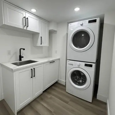 a kitchen with a washing machine and a washer and dryer at Lux Basement Apartment Getaway in Brampton