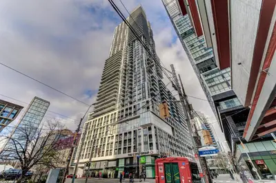 a tall building on a city street with a red phone booth at Downtown Luxury Unit in Toronto