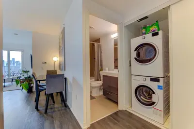 a bathroom with a washer and dryer in a room at Downtown Luxury Unit in Toronto