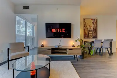a living room with a tv and a table at Downtown Luxury Unit in Toronto