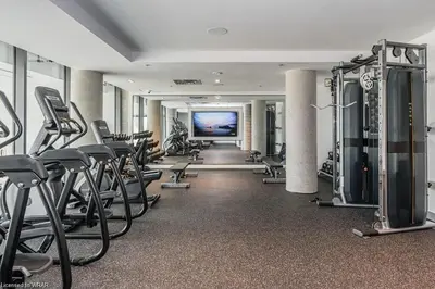 a gym with a bunch of exercise equipment in a room at LuxCondo in the Downtown Kitchener Uptown Waterloo in Kitchener