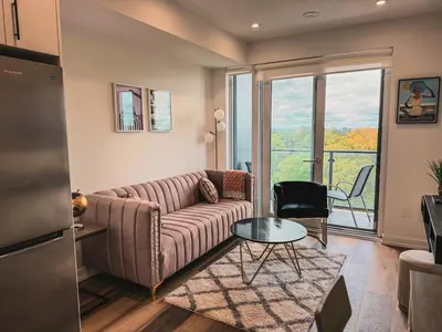 a living room with a couch and a table at LuxCondo in the Downtown Kitchener Uptown Waterloo in Kitchener