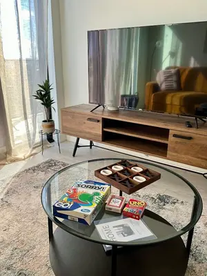 a living room with a glass table with food on it at New Condo With Large Balcony - The Queensway Retreat in Toronto