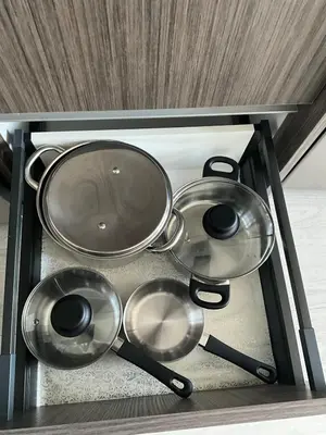 a group of pots and pans in a drawer at New Condo With Large Balcony - The Queensway Retreat in Toronto