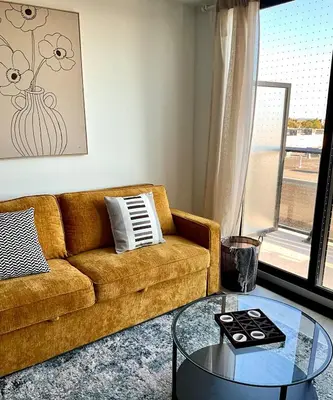 a living room with a couch and a glass table at New Condo With Large Balcony - The Queensway Retreat in Toronto
