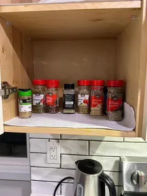 a pantry with jars of spices on a shelf at Luxurious Pvt room & Pvt heated floor bathroom near Airport in Kitchener
