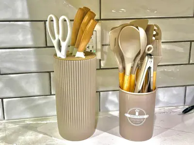 two cups with scissors and utensils on a counter at Luxurious Pvt room & Pvt heated floor bathroom near Airport in Kitchener