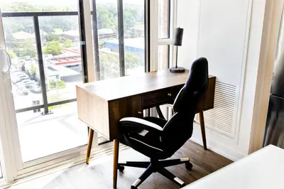 a desk with a chair in a room with a window at Skyline Escape • 3BR Penthouse with Terrace in Toronto