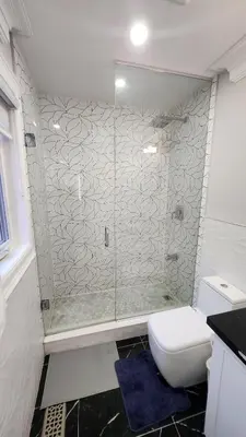 a bathroom with a shower and a toilet at Toronto Guest House in Toronto