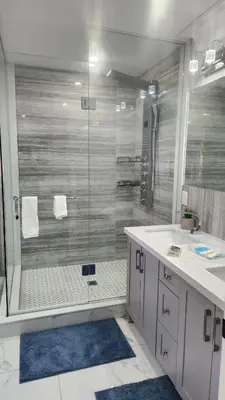 a bathroom with a shower with a glass door at Toronto Guest House in Toronto