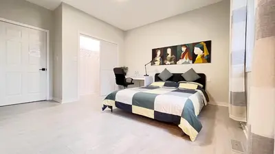 a bedroom with a king sized bed and a desk at Modern Room with En Suite Bath Yonge Finch Sub in Toronto