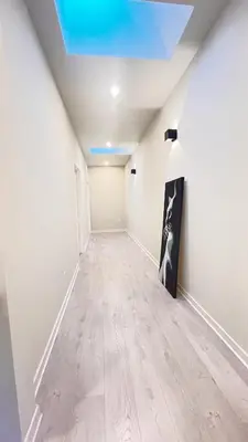an empty hallway with white walls and a blue ceiling at Modern Room with En Suite Bath Yonge Finch Sub in Toronto