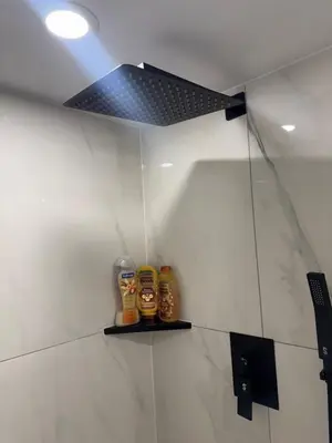 a bathroom with two bottles of beer on a wall at Stylish 2Bedroom Basement Suite in Oakwood Village in Toronto