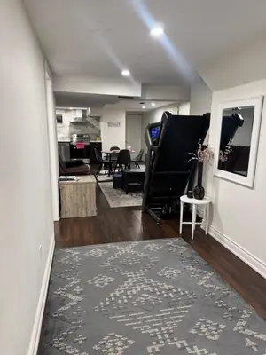 a living room with a rug and a room with a table at Stylish 2Bedroom Basement Suite in Oakwood Village in Toronto