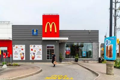 a person walking in front of a mcdonalds restaurant at Stylish 3BR Penthouse with Stunning City Views in Toronto
