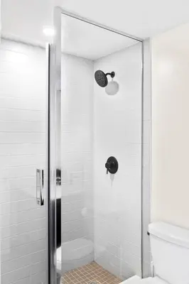 a bathroom with a glass shower with a toilet at Stylish 3BR Penthouse with Stunning City Views in Toronto
