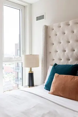 a bedroom with a bed with a large window at Elegant 4BR Condo with City Views & Free Parking in Toronto