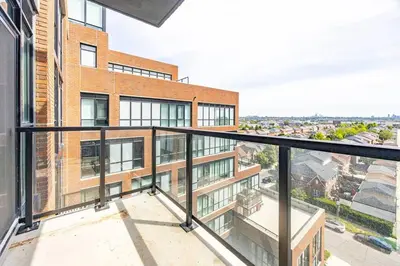an apartment balcony with a view of a building at Elegant 4BR Condo with City Views & Free Parking in Toronto