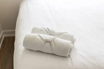 a couple of towels sitting on a bed at Elegant 4BR Condo with City Views & Free Parking in Toronto