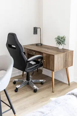 a desk with a black office chair next to it at Elegant 4BR Condo with City Views & Free Parking in Toronto