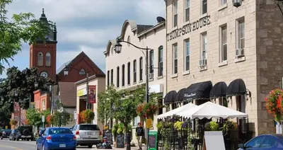 a city street with a building with a clock tower at Cozy Suite in Milton ON Keyless Entry No Pets in Milton