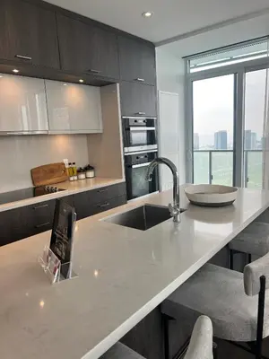 a kitchen with a sink and a counter top at INFIVILLA King Suites & Towers Eaton Toronto in Toronto