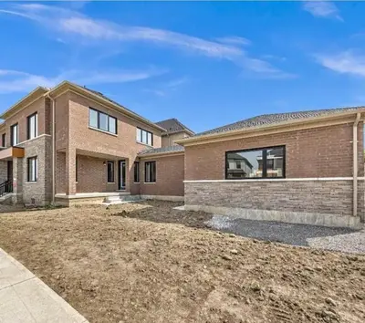 a large brick house with a driveway at 2 Bedroom private Basement apartment in Markham