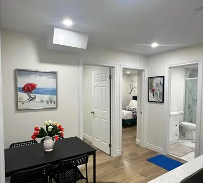 a living room with a table and a bedroom at 2 Bedroom private Basement apartment in Markham
