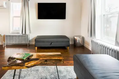 a living room with a couch and a coffee table at Stylishly Remodeled Queen Victoria Loft in Niagara Falls