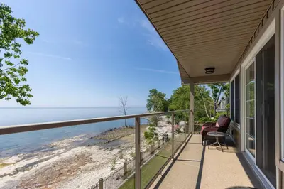a house with a balcony with a view of the ocean at Crystal Beach Executive Waterfront Lakehouse in Fort Erie
