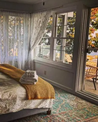 a bedroom with a bed and a large window at Crystal Beach Executive Waterfront Lakehouse in Fort Erie