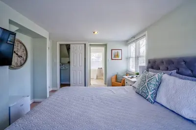 a bedroom with a large bed and a television at Riesling Room Old Town in Niagara on the Lake