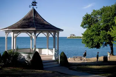 a gazebo on the beach next to the water at Riesling Room Old Town in Niagara on the Lake