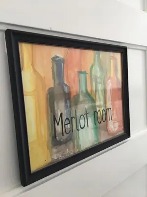 a picture of a painting of bottles on a wall at Merlot Room in Old Town in Niagara on the Lake