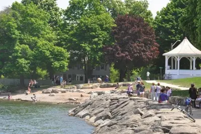a group of people standing on a rock near the water at Merlot Room in Old Town in Niagara on the Lake