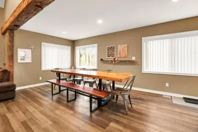 a dining room with a wooden table and chairs at Family friendly Getaway Steps to the beach in Fort Erie