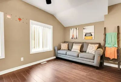 a living room with a couch and a window at Family friendly Getaway Steps to the beach in Fort Erie