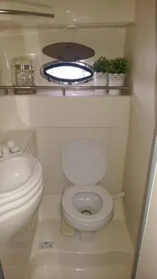a small bathroom with a toilet and a sink at Bobs Yer Uncle in Port Dalhousie in St. Catharines