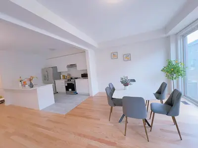 a dining room and kitchen with a table and chairs at Vantage stay Modern 4BR townhouse pickering in Pickering