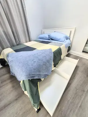 a bedroom with a bed with a white bed frame at Cozy Private Room Near Downtown Toronto in Toronto